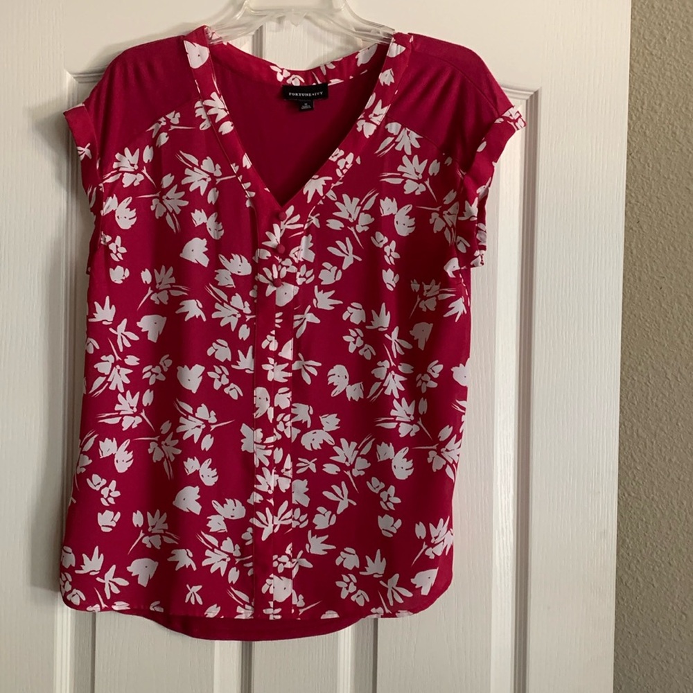 Ladies medium top on red with white leaves. Shirt sleeve .